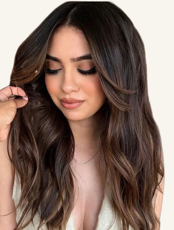 Dimensional espresso brunette hair color with soft face-framing highlights, polished waves, and reflective shine.