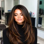 Luxury brunette hair color with caramel dimension and long layered styling at premium hair salon near Baldwin Park Florida