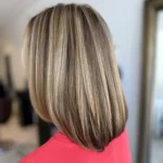 Dimensional beige blonde hair color with highlights, lowlights, and reflective shine at Box Office Hair in Winter Springs, Florida.