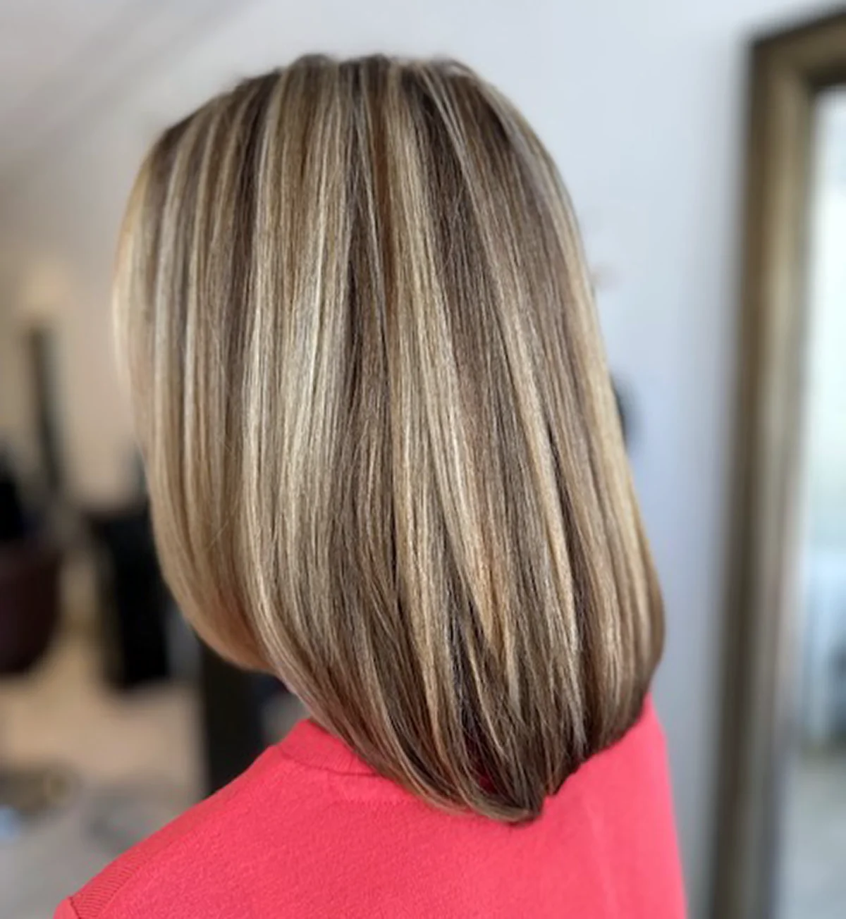 Dimensional beige blonde hair color with highlights, lowlights, and reflective shine at Box Office Hair in Winter Springs, Florida.