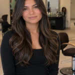 Signature precision haircut with long layered brunette hair, soft face-framing layers, dimensional shine, and luxury salon styling.